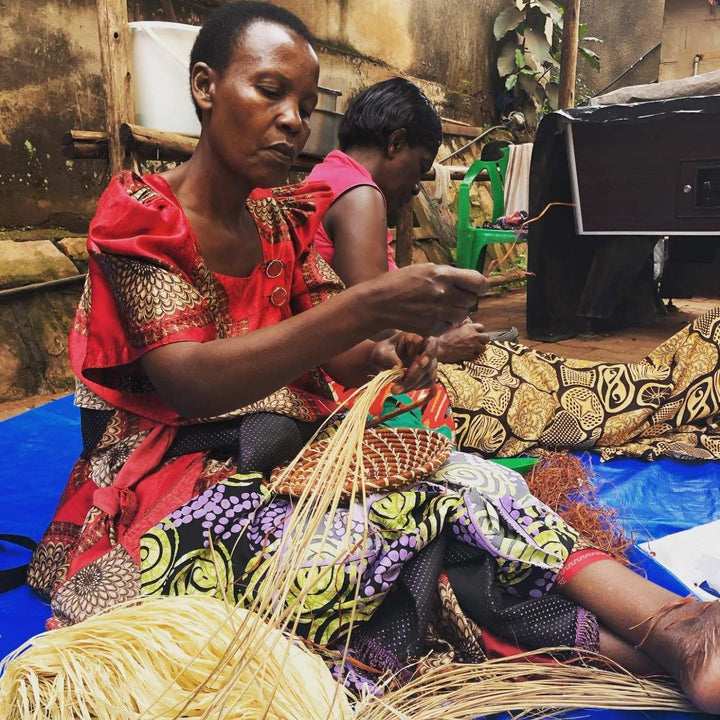 AfriBeads help women in Uganda build sustainable livelihoods. Here the artisans are weaving natural banana palm into baskets using a traditional African coiled weaving style. 