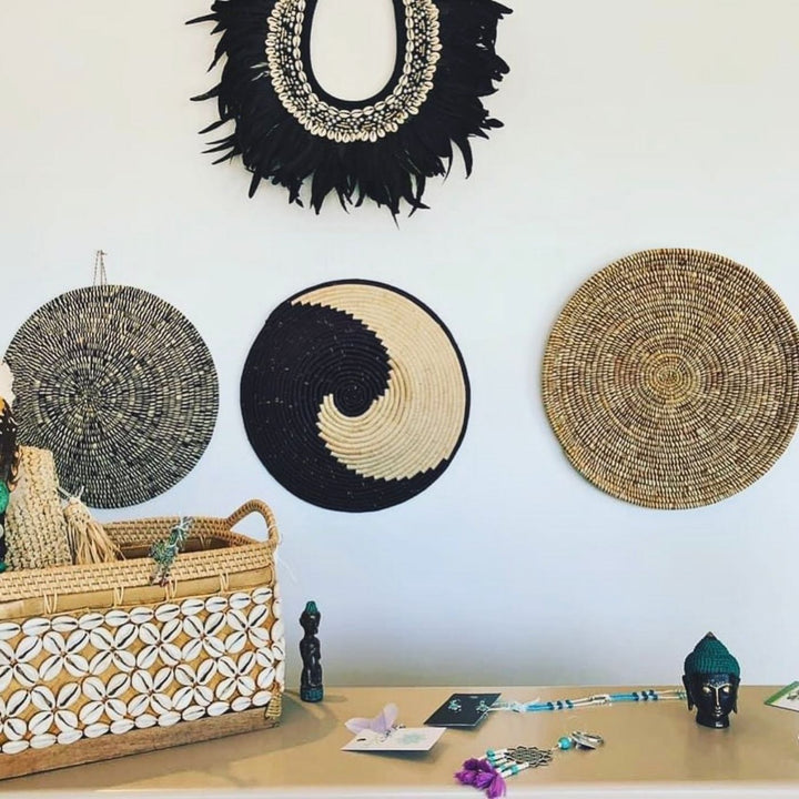 Wall display with AfriBeads baskets at this beautiful eclectic homewares store. Artisan goods celebrating African craft. Home decor, baskets, and jewelry that are handmade and ethically produced in Africa.