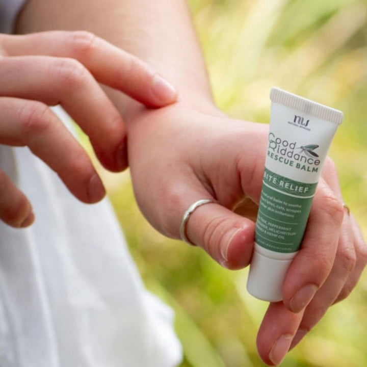 A 10g tube of Good Riddance Rescue Balm. The white and green tube is labelled “Bite Relief” and notes that it soothes insect bites, cuts, scrapes, and skin irritations. The packaging highlights key ingredients such as tea tree, peppermint, lavender, helichrysum, tamanu, and hemp oil.
