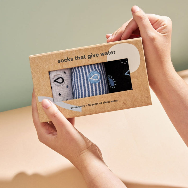 Conscious Step - Give Water Gift Box is a 3-pack set of comfy, organic cotton socks designed to support access to safe water globally. Each box includes three pairs in blue-striped, grey-polka dot, and blue paisley patterns. Knit from Fairtrade, GOTS-certified and vegan materials, these socks deliver soft cushioning, durable comfort and a clean, classic look.