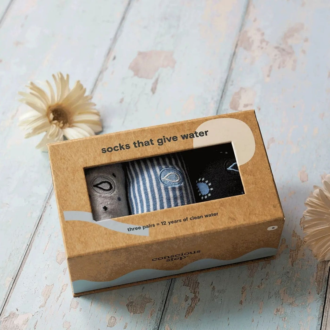 Conscious Step - Give Water Gift Box is a 3-pack set of comfy, organic cotton socks designed to support access to safe water globally. Each box includes three pairs in blue-striped, grey-polka dot, and blue paisley patterns. Knit from Fairtrade, GOTS-certified and vegan materials, these socks deliver soft cushioning, durable comfort and a clean, classic look.