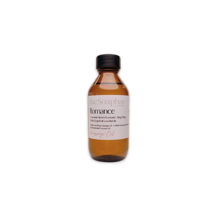 Romance Massage Oil by The Soap Bar in amber glass bottle, made with apricot kernel oil and coconut oil, scented with lavender and ylang ylang essential oils.