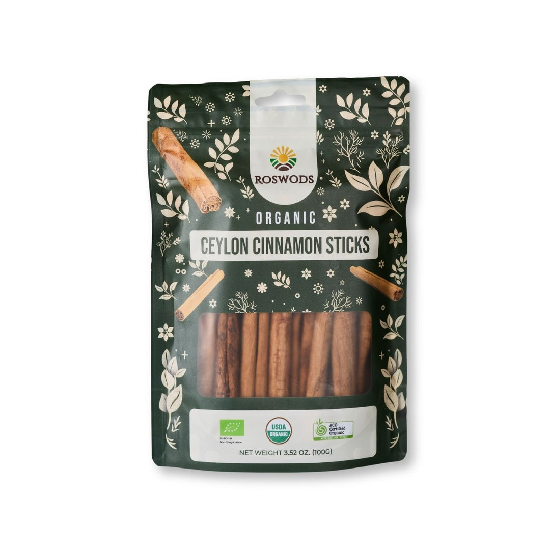 Roswods Organic Ceylon Cinnamon Sticks 100g resealable dark green pouch with botanical packaging, whole cinnamon sticks visible through a clear window, and Bio, USDA Organic, and ACO Certified Organic badges at the base.