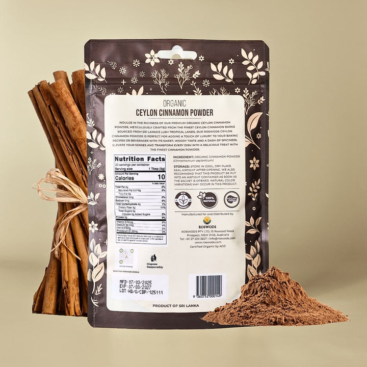 Back of Roswods Organic Ceylon Cinnamon Powder bag showing Nutrition Facts panel and product information, displayed with cinnamon sticks and loose cinnamon powder on a warm beige background.