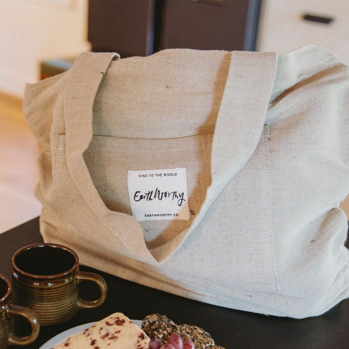Earth Worthy Hauler Mini everyday tote bag in soft washed linen-look jute cotton canvas. Natural and durable with two pockets, 30cm handle. Ethically made from natural jute, this tote bag supports survivors of Rana Plaza and promotes sustainable, plastic-free shopping.