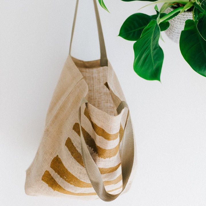 Earth Worthy Grocery Bag - Strength. Ethically made from natural jute, this bag supports survivors of Rana Plaza and promotes sustainable, plastic-free shopping.