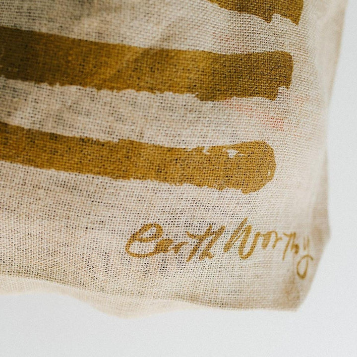 Earth Worthy Grocery Bag - Strength. Ethically made from natural jute, this bag supports survivors of Rana Plaza and promotes sustainable, plastic-free shopping.