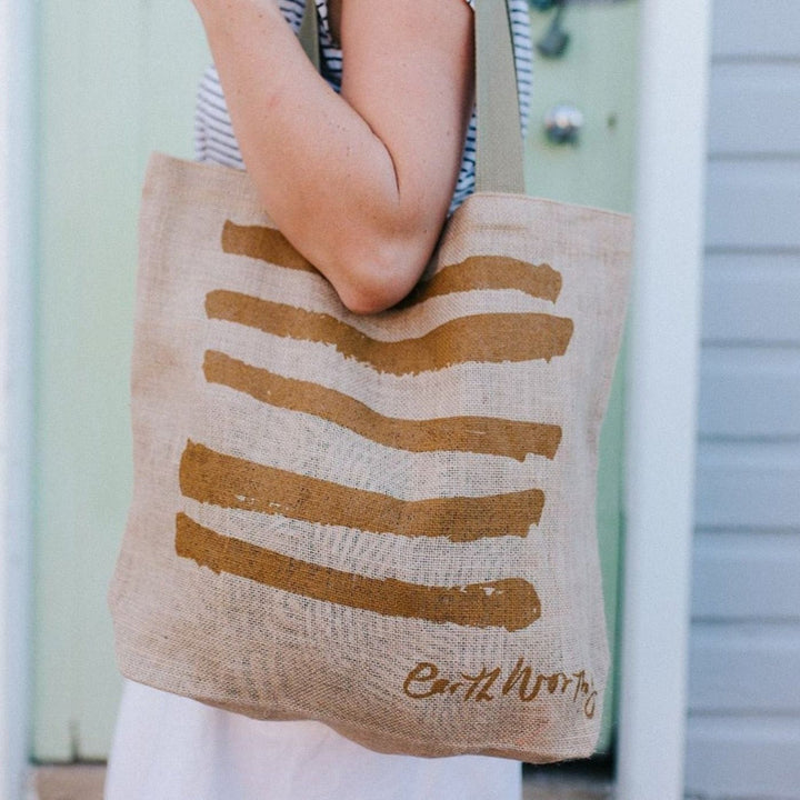 Earth Worthy Grocery Bag - Strength. Ethically made from natural jute, this bag supports survivors of Rana Plaza and promotes sustainable, plastic-free shopping.