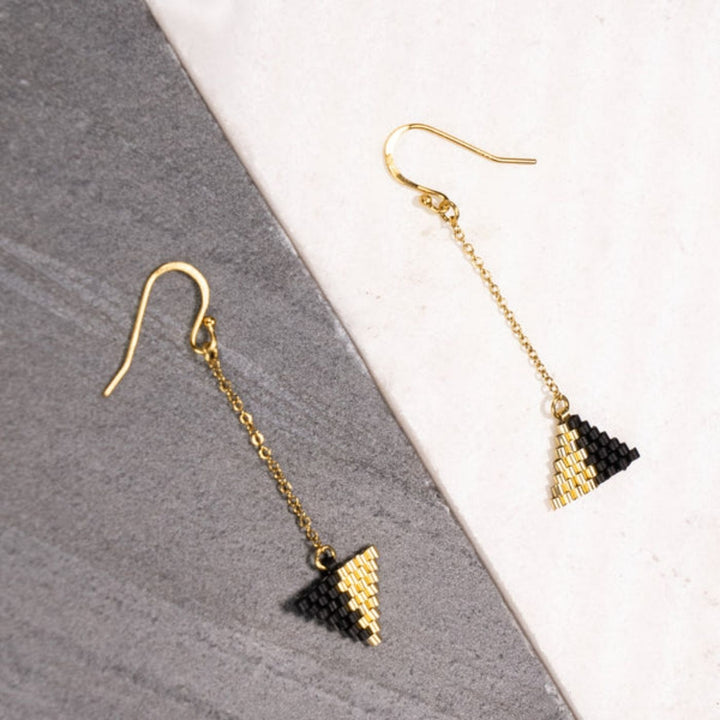 Eden Be Light Beaded Ethical Gold Earrings. Handcrafted with black glass beads and 18K gold-plated stainless steel, these ethical earrings support women rebuilding their lives through Eden’s programs.