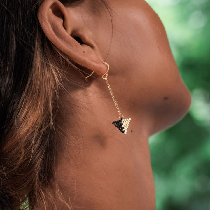 Eden Be Light Beaded Ethical Gold Earrings. Handcrafted with black glass beads and 18K gold-plated stainless steel, these ethical earrings support women rebuilding their lives through Eden’s programs.