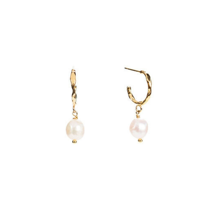 Milk & Honey Hoop Earrings feature a freshwater pearl on 18K gold-plated stainless steel hoops. Profits support women from trafficking through Eden’s programs.