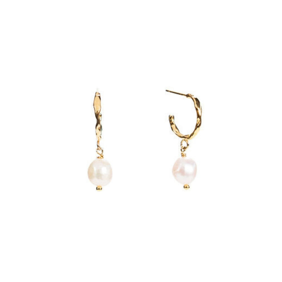 Milk & Honey Hoop Earrings feature a freshwater pearl on 18K gold-plated stainless steel hoops. Profits support women from trafficking through Eden’s programs.