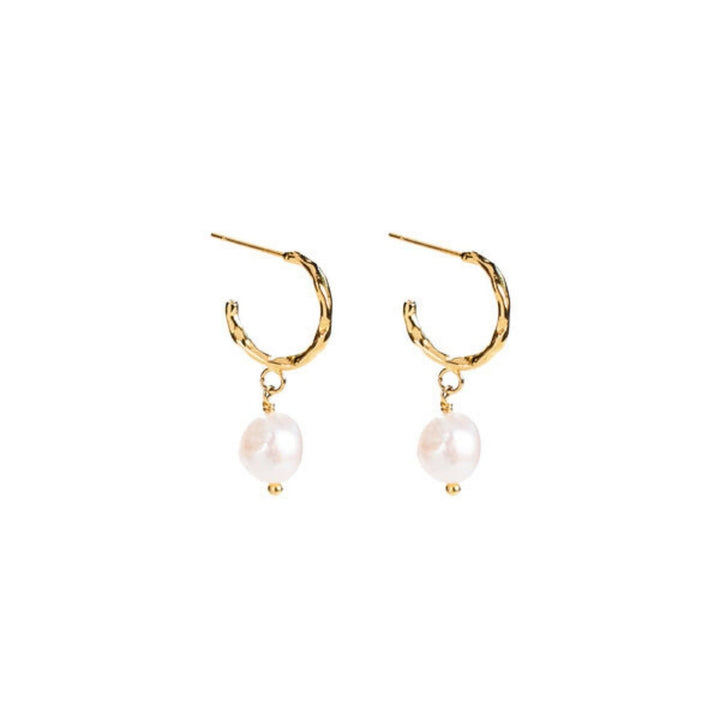 Milk & Honey Hoop Earrings feature a freshwater pearl on 18K gold-plated stainless steel hoops. Profits support women from trafficking through Eden’s programs.