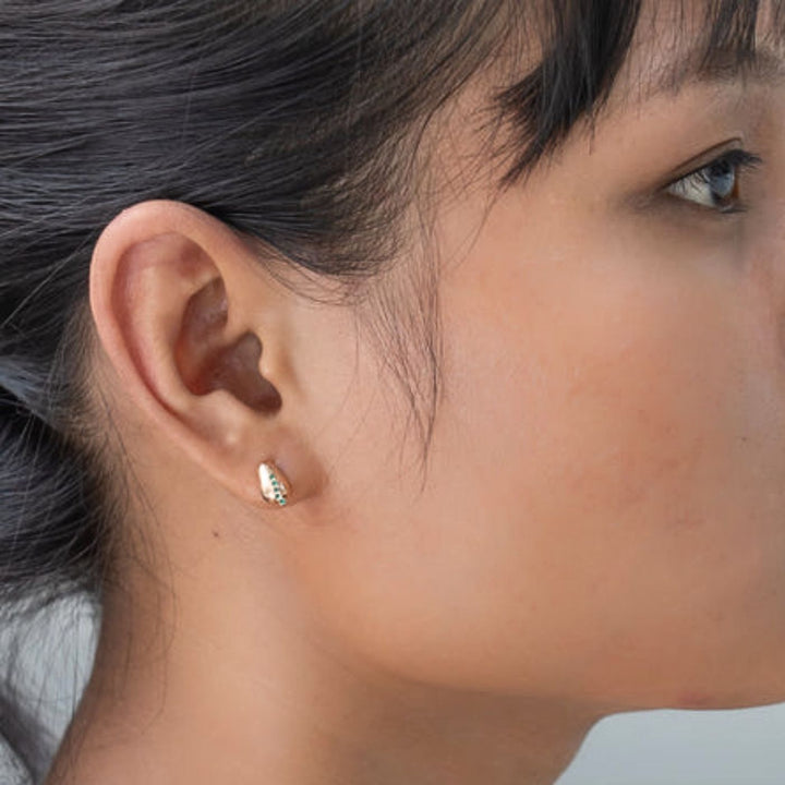 Radicle Post Earrings feature emerald cubic zirconia on medical-grade stainless steel. Profits support women rescued from trafficking through Eden’s programs.