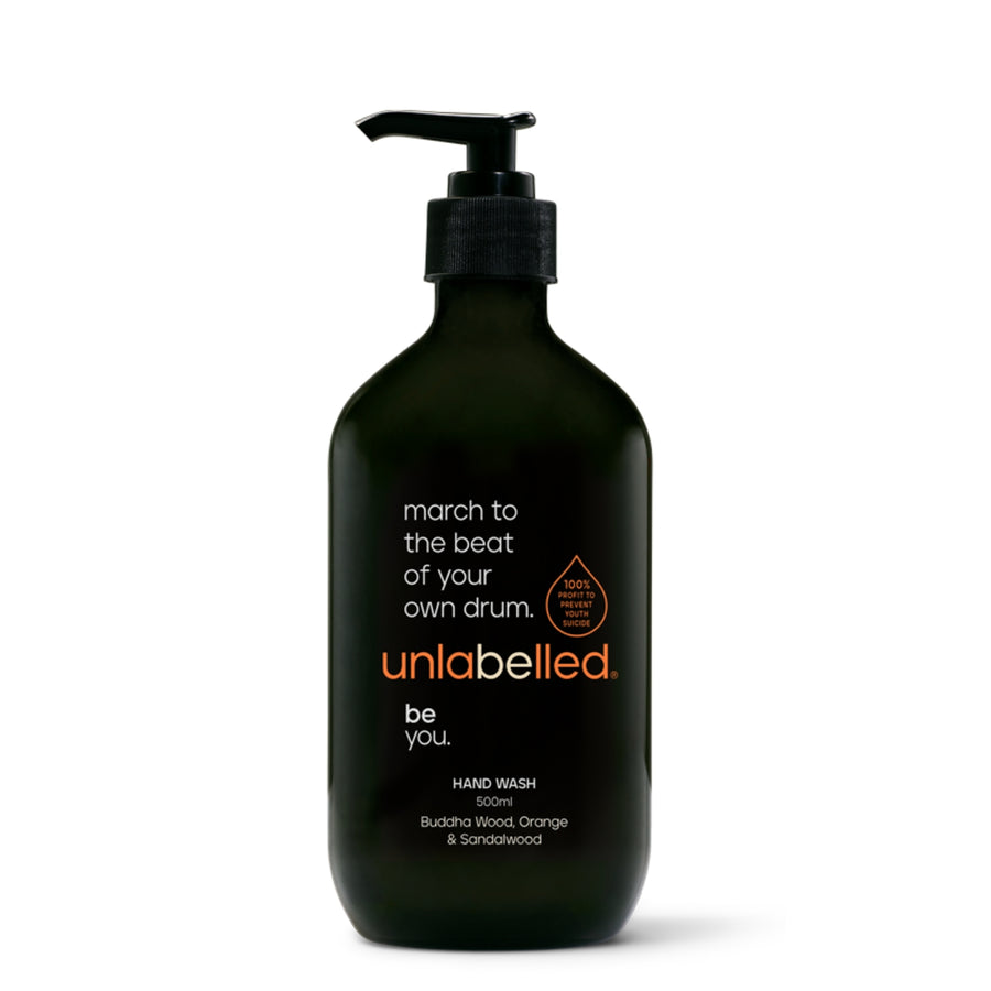 Unlabelled Hand Wash - 500ml bottle with buddha wood, orange, and sandalwood notes. Sleek black packaging with an empowering message: 'march to the beat of your own drum'. Unlabelled is a not-for-profit social enterprise dedicated to transforming youth mental health in Australia. With 100% of profits funding critical mental health initiatives.