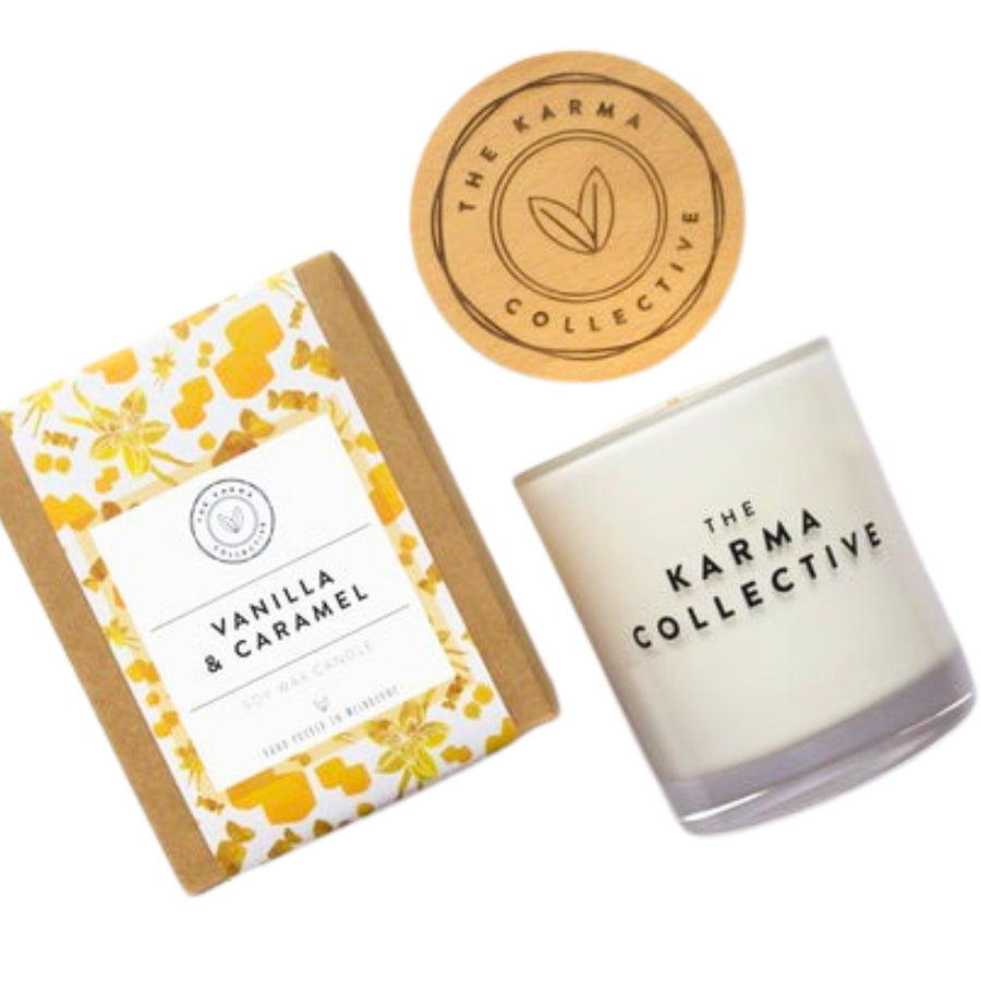 The Karma Collective Vanilla & Caramel Soy Wax Candle in an elegant white glass jar with a wooden lid. A warm, sweet scent with ethically sourced ingredients. 50% of each Karma Collective premium soy candle's profits are donated to World Animal Protection Australia.