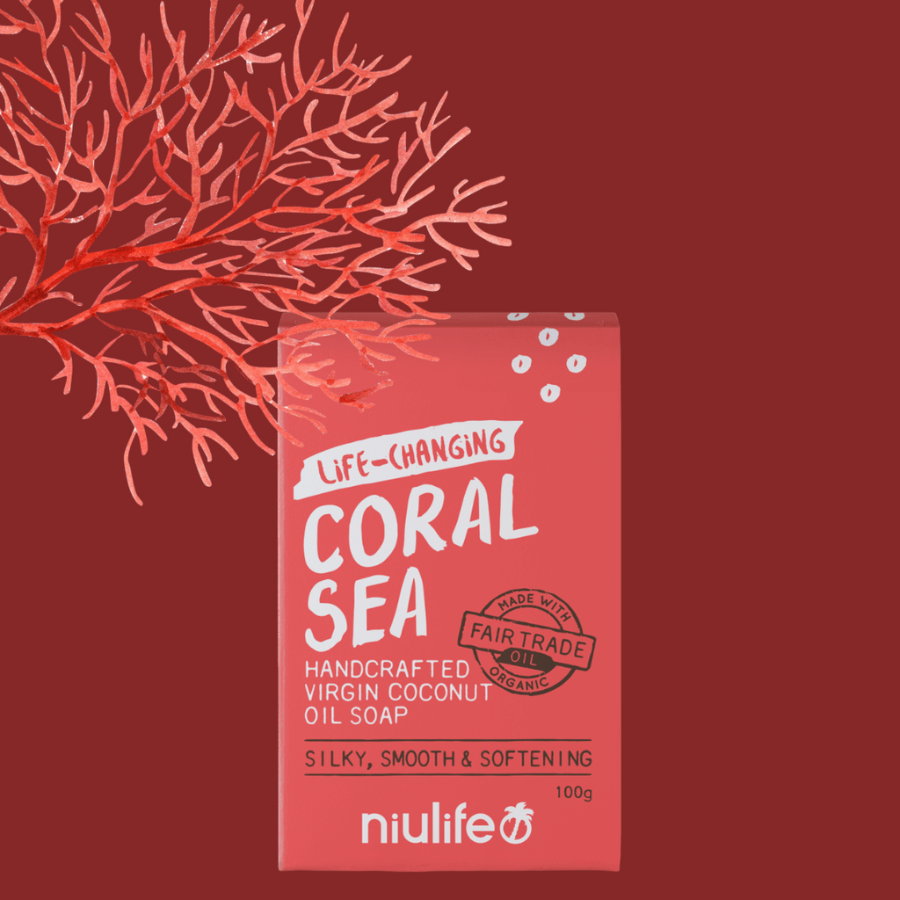 Red box against a dark maroon background with image of a red coral. Box contains virgin coconut oil soap with label showing that the oil is coconut is hand pressed and the oil changes lives of the people who make it where 100% of the profits are donated